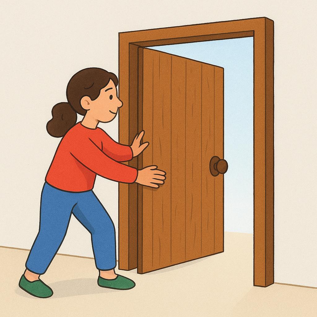 A person holding a heavy wooden door open with their hand and foot to let others pass.