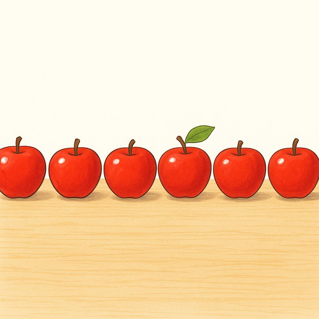 Seven bright red apples neatly arranged in a single line on a simple wooden surface.