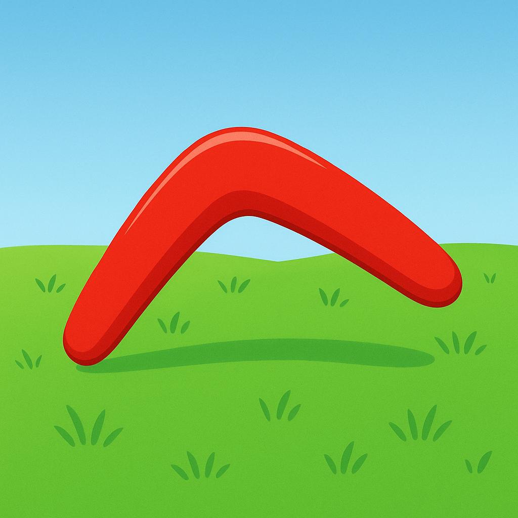 A bright red boomerang, shaped like a letter V, rests simply on a patch of green grass under a blue sky.