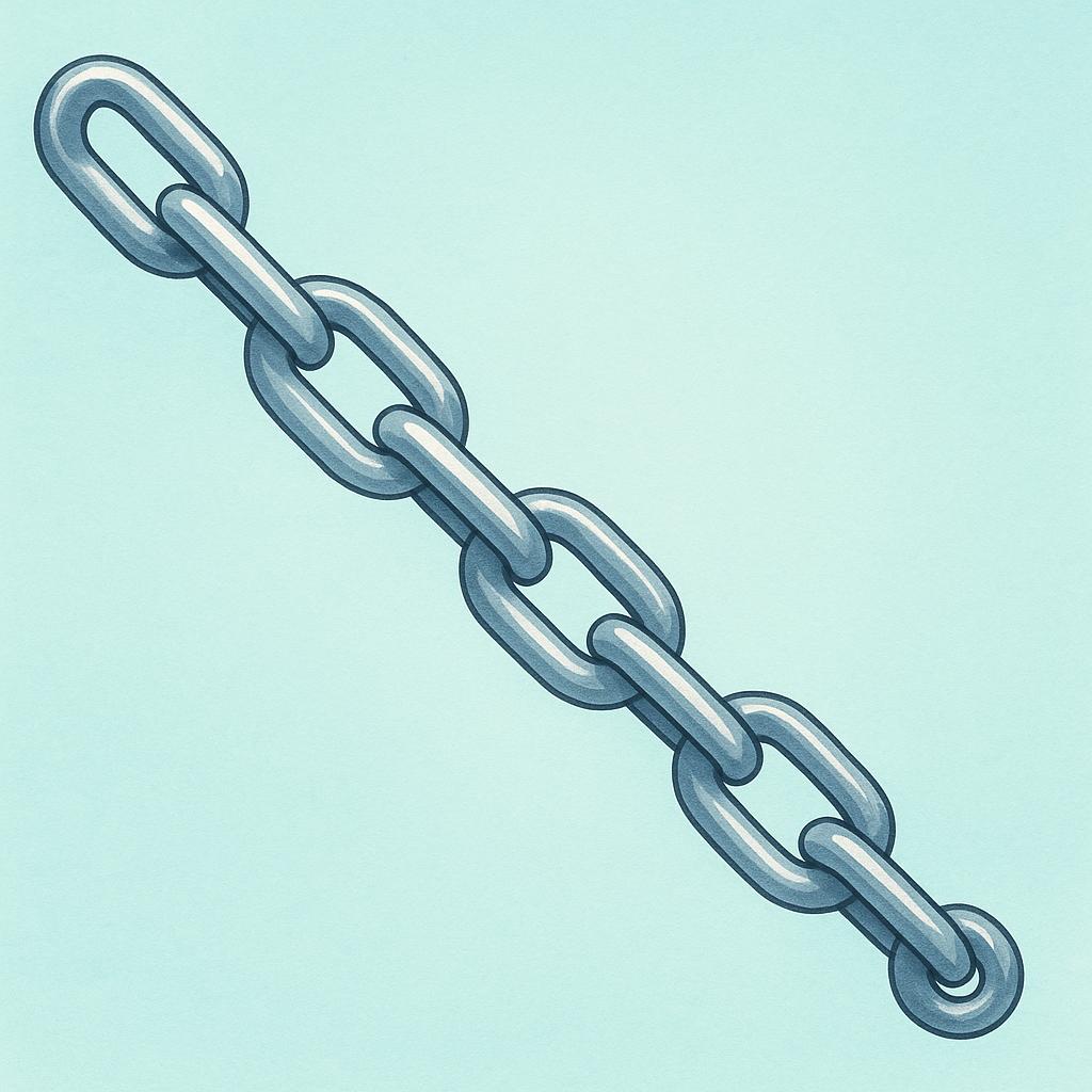 A close-up view of several interlocking metallic chain links lying on a surface.